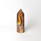 Agate crystal with brown and yellow patterns on a white background